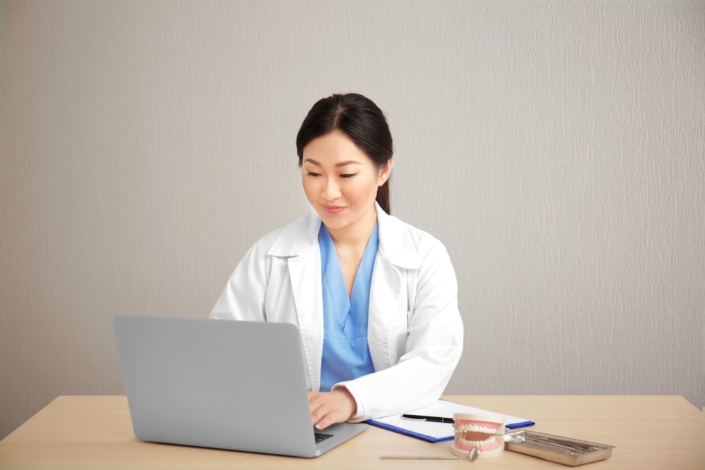 Dentist using laptop