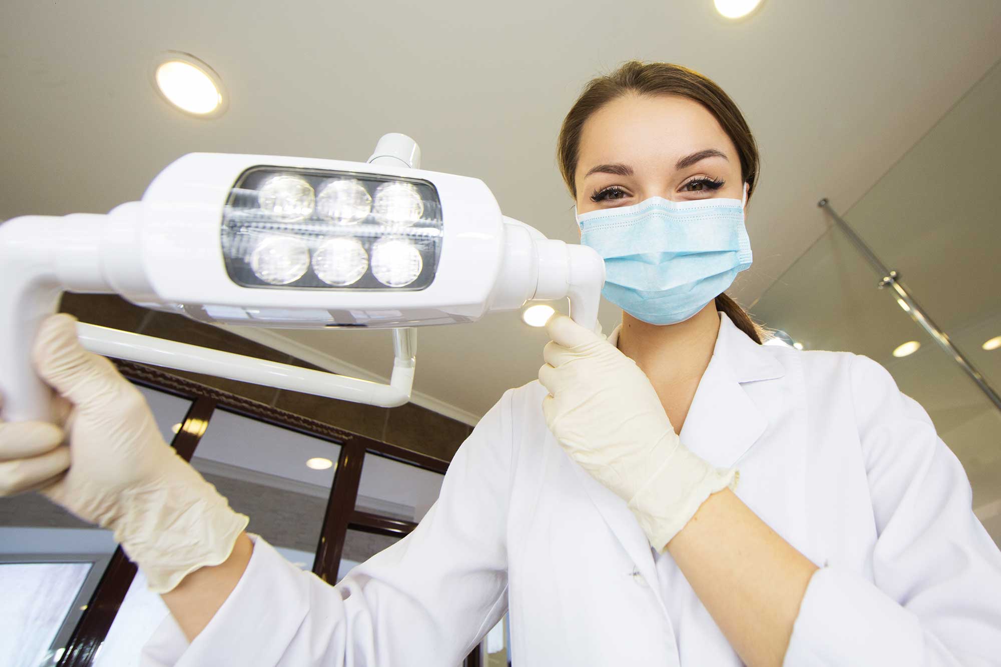dentist dental practice young gloves mask management risk sterile patient surgical instruments pointers starting protected held hands readily approaching